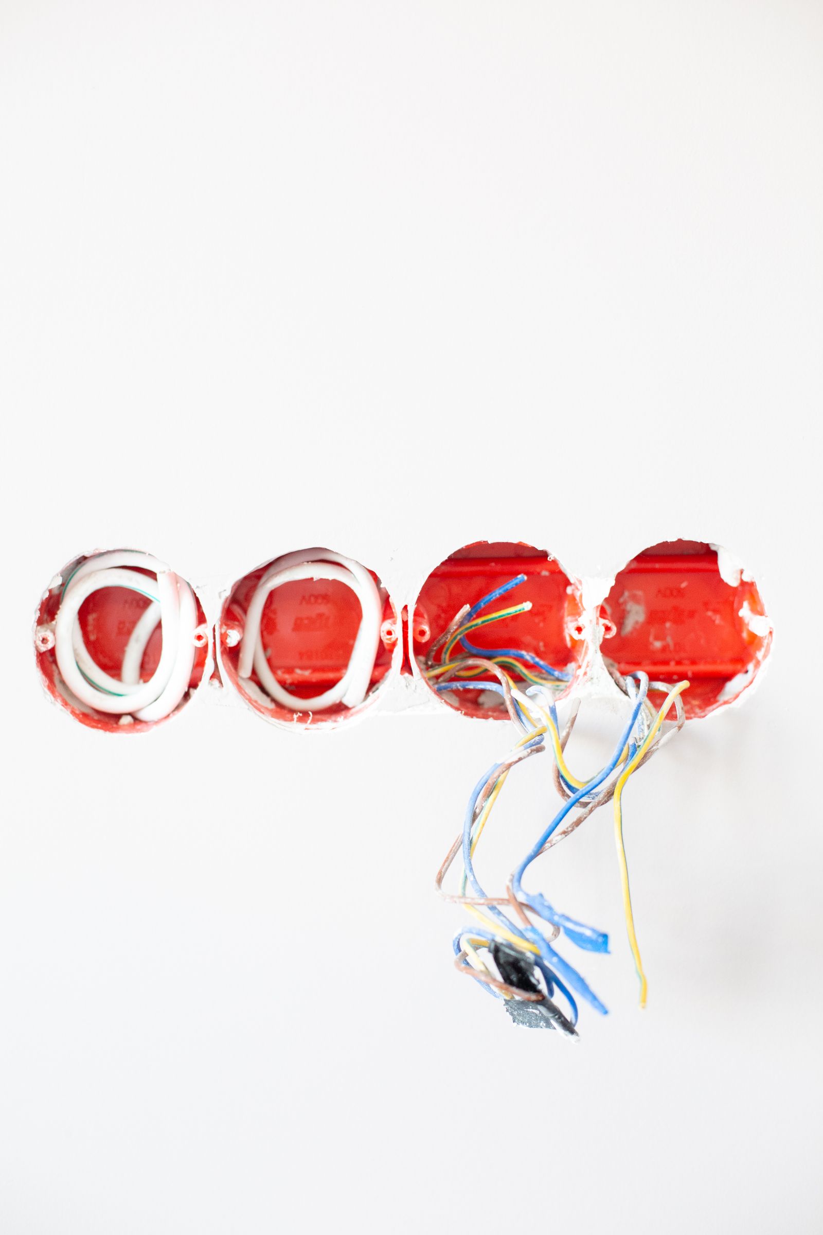 Sample image of new wiring coming out of red back boxes in a white wall