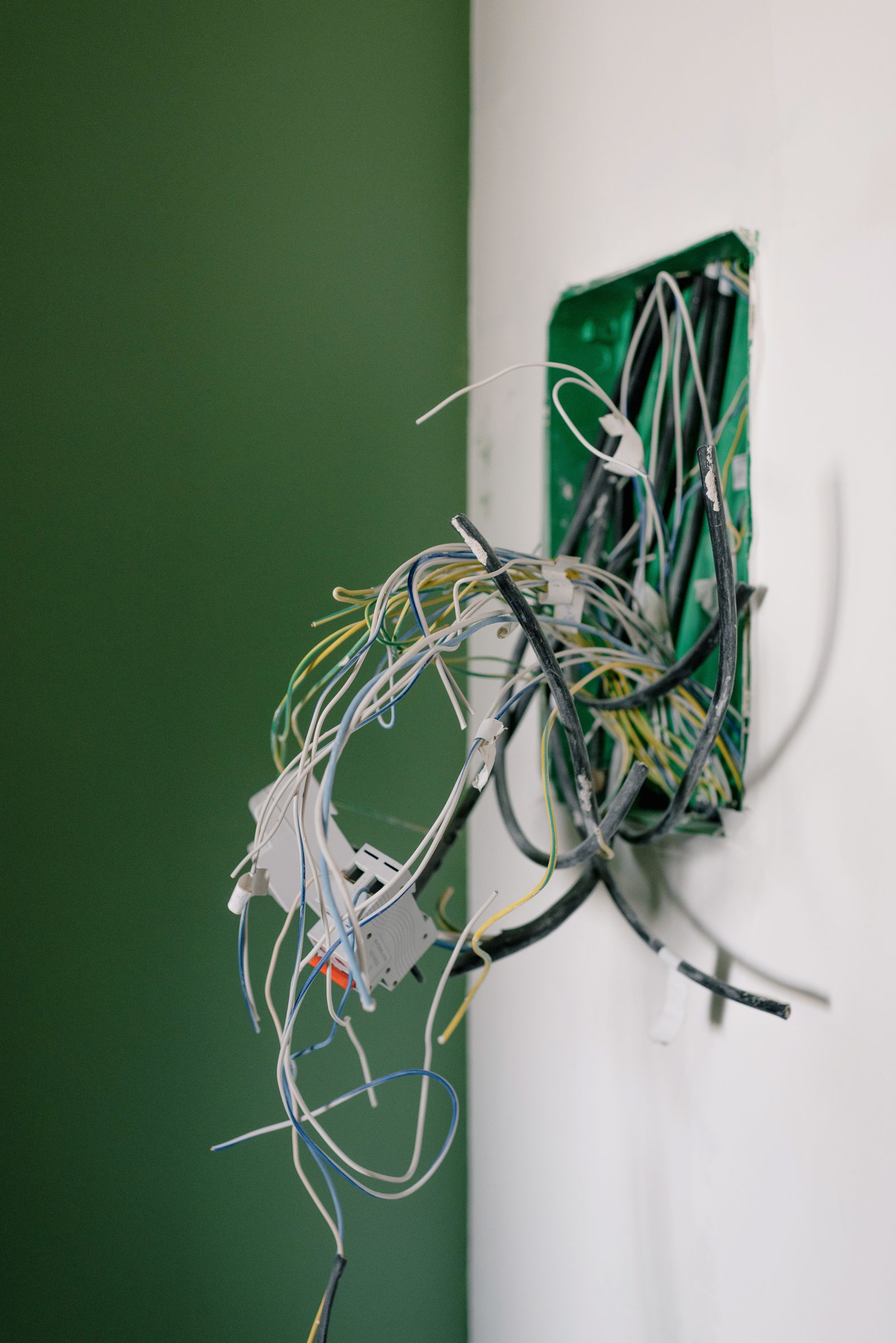 Sample image of an open socket box with loose wires during a repair